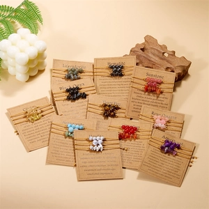 Detail showing 11 sets of gemstone braided bracelets on kraft cards with natural decor