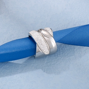 Macro detail of silver wide hollow crisscross ring with micro-pave zirconia stones
