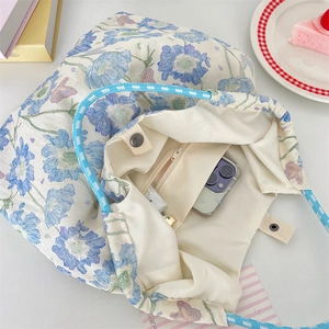Internal view of floral canvas tote bag showing zipper pocket and spacious capacity