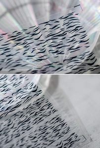 Detail of 5D embossed tiger stripe nail stickers with matte translucent texture