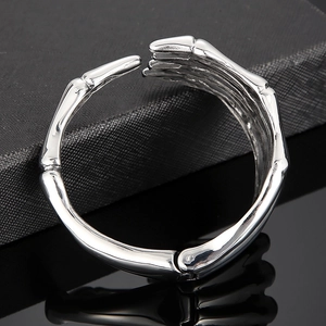 Macro shot of silver skeleton hand bracelet with polished titanium steel finish