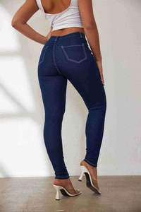 Detail of high waisted skinny jeans with white contrast stitching and back pocket design