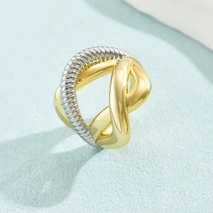 Detail of 18K gold and silver two-tone interlaced twisted ring with cable textures