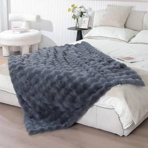 Close-up of thick dark grey plush blanket with 3D bubble texture and soft Tuscan rabbit fur