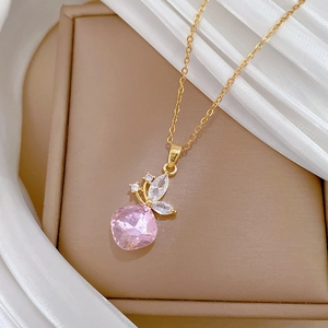 Elegant gold butterfly necklace with a large pink crystal pendant on a jewelry box