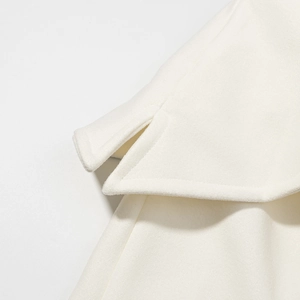 Detailed macro shot of premium white wool coat cuff with precision slit tailoring