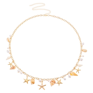 Detail of bohemian gold waist chain featuring starfish, seashells and white pearls