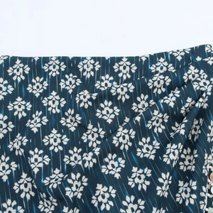 Floral print skort in dark cyan with white retro patterns and vertical textures