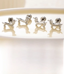 Detail of silver dachshund dog stud earrings in titanium steel with zircon accents
