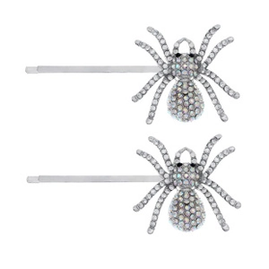 Detailed view of two silver spider hair clips with sparkling rhinestones on white background