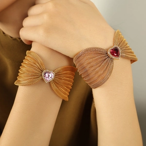 Elegant gold mesh bracelet featuring heart-shaped pink and ruby red crystal butterfly charms