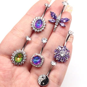 Selection of zircon belly rings featuring dragonfly, lotus, and yin-yang designs