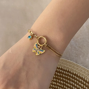 Double-layered golden stainless steel bracelet with colorful butterfly and blue gem pendant
