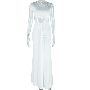 Detail of white maxi dress showing waist cutout design and elegant pleated textures