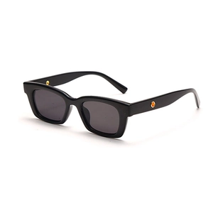 Fashionable small frame black sunglasses with decorative circular side pins and dark lenses