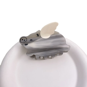 Cute pig-shaped acetate hair claw clip with grey marble pattern and tiny white wings