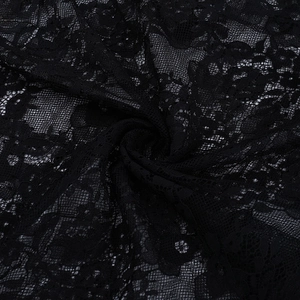 Detailed macro shot of premium black lace fabric with delicate floral hollow patterns