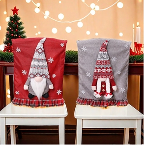 Detail of Christmas gnome chair covers with red plaid ruffles and snowflake embroidery
