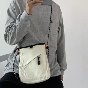 Unisex cream canvas crossbody bag with rope strap and diagonal zipper pocket for daily use