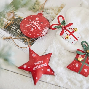Christmas metal hanging ornaments with red stars and gift box on winter snow background