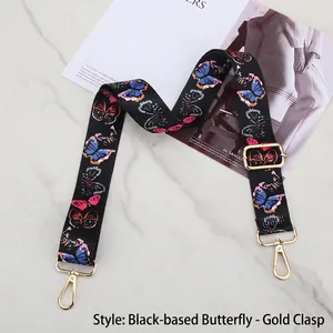 Close-up of ethnic butterfly pattern wide strap with premium gold metal hardware buckles