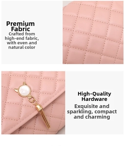 Detail of pink quilted pattern fabric and golden cat charm with tassel hardware