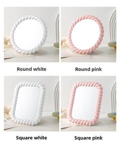 Detail of adjustable desktop makeup mirrors with cream-style twisted rope frames in pink and white