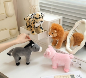 Detailed view of four stuffed animals including a lion and leopard in a cozy home setting