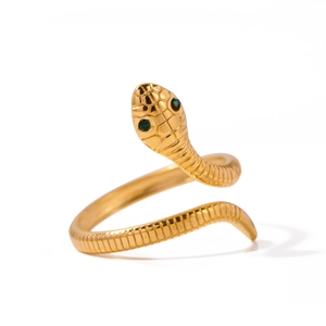Minimalist gold snake ring with green stone eyes and detailed scale texture
