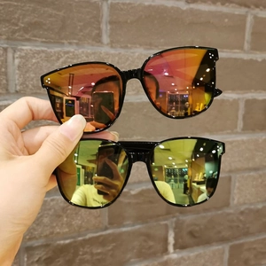 Detail showing kids' sunglasses with black frames, colorful mirror lenses and metal rivets