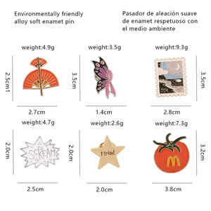 Detail view of 6 cartoon enamel pins showing exact dimensions and weight measurements