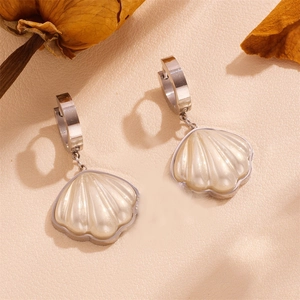 Detailed view of silver stainless steel shell earrings with pearlescent white finish