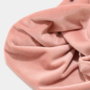 Close-up of thick pink velvet fabric showing soft texture and thermal lining