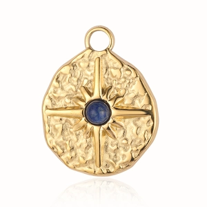 Macro shot of gold sunburst pendant with hammered texture and blue natural stone inlay