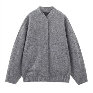 Gray textured bomber jacket with stand collar, flap pockets and elastic hem on plain background