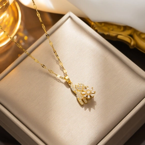 Golden rotating bear necklace with full zircon micro-pave pendant on jewelry box