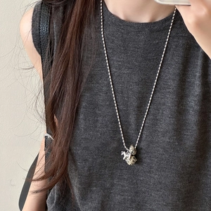 Detailed view of a silver long necklace featuring a cute 3D dalmatian animal pendant