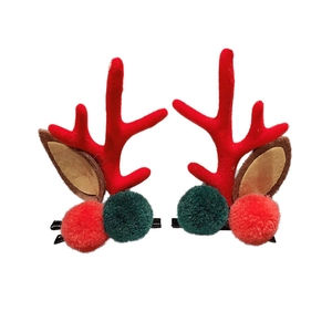 Christmas reindeer antler hair clips with red and green pom poms for holiday styling
