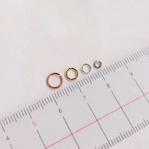 Assorted gold and silver jump rings in 4mm to 6mm sizes shown on a measuring ruler
