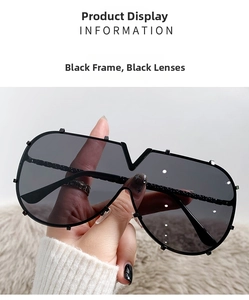 Detail of fashion shield sunglasses featuring a unique V-shaped notch and silver studs