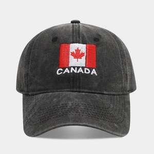 Detail of embroidered Canada flag and text on a black washed cotton baseball cap