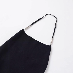 Black knit top featuring adjustable thin shoulder straps with elegant silver bead accents