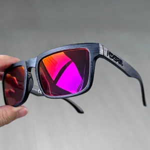 Detail of matte black brushed frame texture and red polarized lenses on sport sunglasses