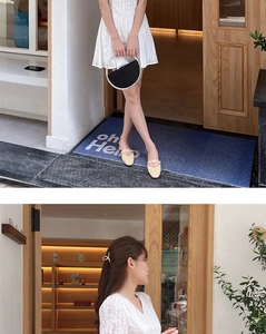White lace dress paired with a black semi-circular pearl handle bag for a dinner party