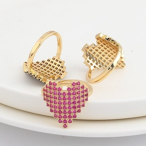Detailed view of pixel heart rings with pink pavé stones and 18K gold plated finish