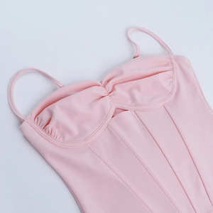 Detail of pink corset top featuring corset-style boning and high-elastic knit fabric
