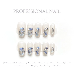 Detail of luxury long press-on nails with 3D heart crystals and silver glitter shimmer