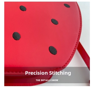 Detailed close-up showing precise stitching on strawberry-shaped red leather round bag