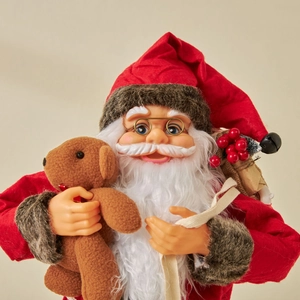 Classic red Santa Claus doll holding a teddy bear for festive Christmas window display decor