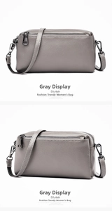 Detail view of grey litchi grain leather crossbody bag with silver hardware accents